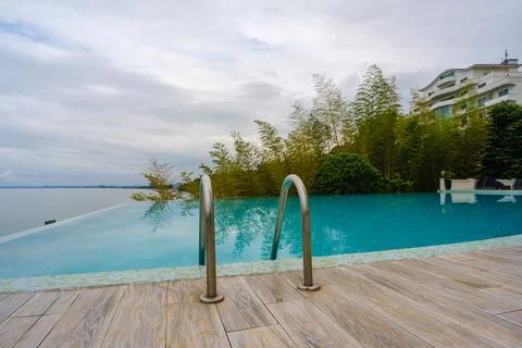 Perspective view of an outdoor infinity swimming pool at sunset Stock Photos