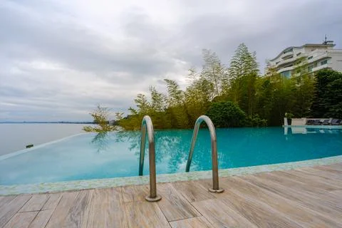 Perspective view of an outdoor infinity swimming pool at sunset Stock Photos
