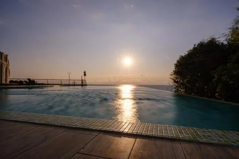 Perspective view of an outdoor infinity swimming pool at sunset Stock Photos