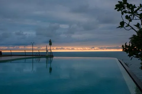 Perspective view of an outdoor infinity swimming pool at sunset Stock Photos