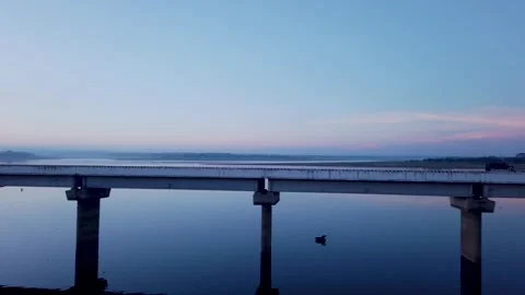 A Perspective view of an Over Bridge and the river shot from a moving train. Stock Footage 272768380