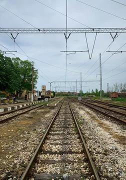 Perspective view of parallel railways under cloudy sky. Stock Photos