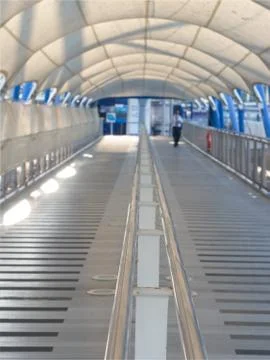 Perspective view of pathway with silver color handrails and white canvas roof Foto stock