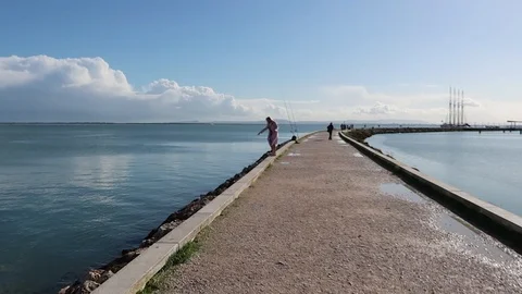 Perspective view of the pier in the middle of the sea bay. Young woman 스톡 동영상 127708390