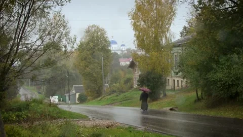 Perspective view of the priest walking along the roadway opposite the Church in Stock Footage 133347485