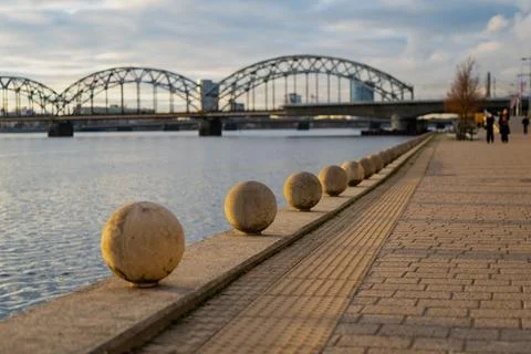 Perspective view of riverside walkway in Riga with granite sphere barriers Stock Photos