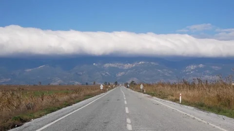 Perspective View Of The Road And Distant Mountains In The Clouds Stock Footage 195931454