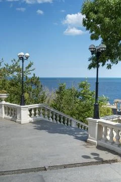 Perspective view of steps leading down to the blue Mediterranean horizon. Sunny Stock Photos