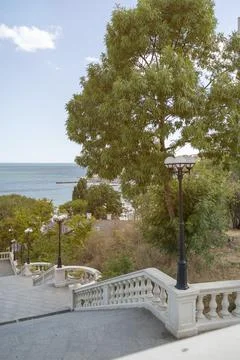 Perspective view of steps leading down to the blue Mediterranean horizon. Sunny Stock Photos
