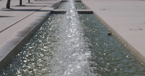 Perspective view straight along a row of water fountains Stock Footage 135099241