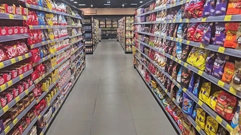 Perspective view of a supermarket aisle filled with snacks and sweets on Stock Footage 338259334