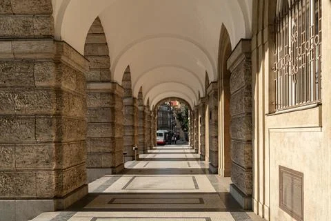 Perspective view through a covered stone colonnade Arcade with vaulted whit.. Stock Photos