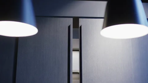 Perspective view through dark cabinet doors into illuminated modern kitchen Stockbeeldmateriaal 155208248