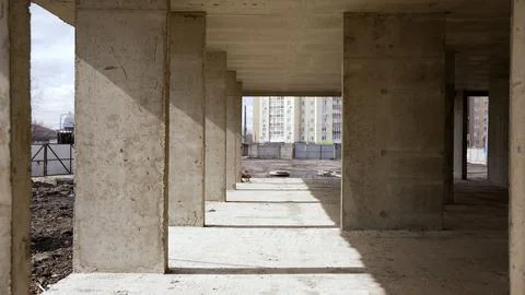 Perspective view through rough concrete columns at an urban construction site Фото