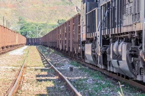 Perspective view of train wagons of iron ore and rails, industry. Stock-Fotos