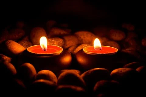 Perspective view of two burning candles Stock Photos
