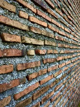 Perspective view of uneven rough old red brick wall background Stock Photos