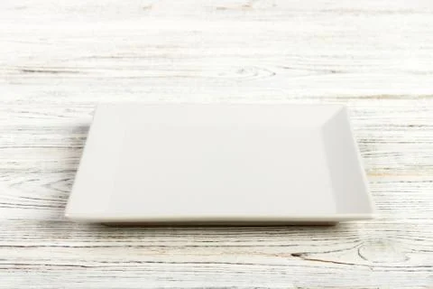 Perspective view. white square plate on a wooden table Foto stock