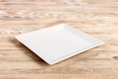 Perspective view. white square plate on a wooden table Foto stock