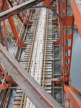 Perspective view of a worn, red-gray industrial structure possibly bridge o.. Stock Photos