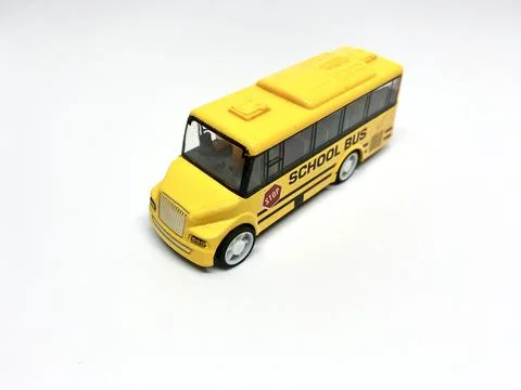 Perspective view of yellow school bus toy for kids isolated on white background Stock Photos