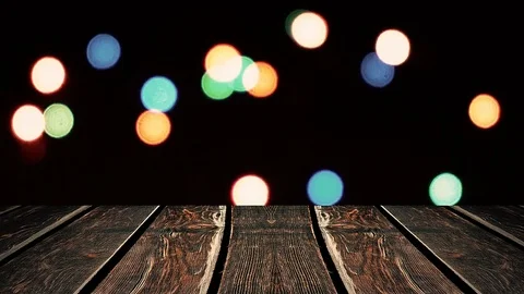 Perspective wood and bokeh background of night and the shimmering glare of the Vídeos de archivo 77408027