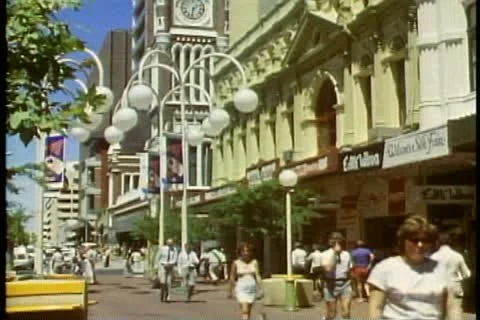PERTH, AUSTRALIA, 1985, downtown, medium shot, crowd, tilt up clock tower Stock Footage 11627940