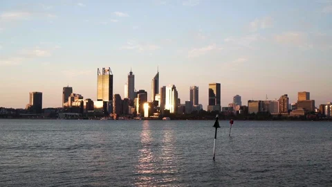 Perth city skyline across river with sunset light reflecting off buildings Stock Footage 122019516