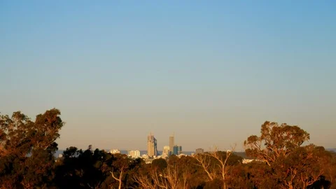 Perth city skyline sunset time-lapse shadows on trees Stock Footage 108655336