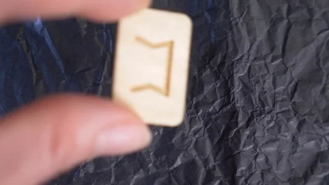Perth inverted rune. close-up, hand puts the rune on the surface for divination Stock Footage 87880590