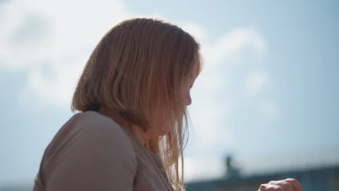 Perturbed Mom Waiting Under Sun Checking Time with Concern Vídeo Stock 322672375