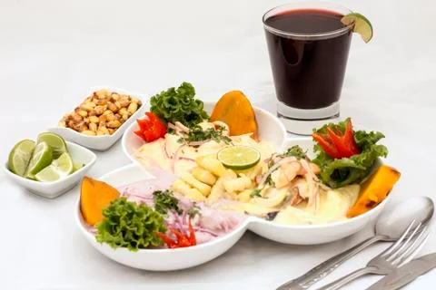 Peru Dish: 3 types of Cebiche (ceviche) with chicha drink, lemon and canchita Stock Photos