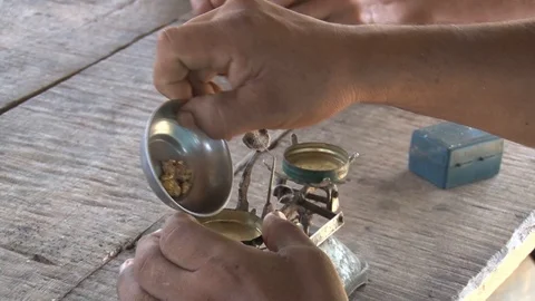 Peru illegal gold mining in the Amazon miner weighing gold Stock Footage 86325991