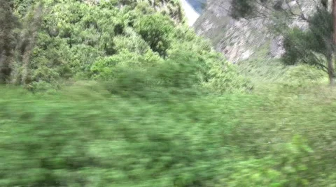 Peru Rail passes river bend Stock Footage 378112