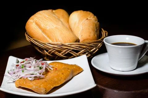 Peruvian breakfast, popular Peruvian tamale with onion sauce, breads and a cup Stock Photos