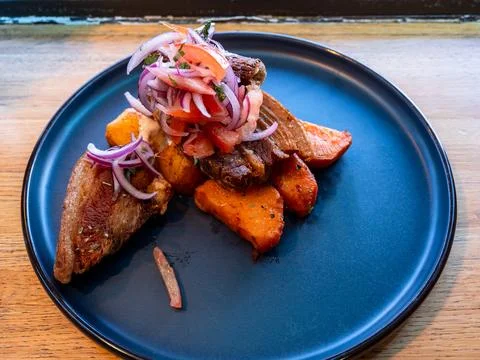 Peruvian Chicharron de cerdo simmered pork belly Stock Photos