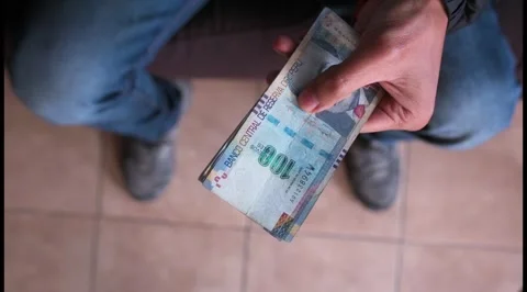 Peruvian coin in the hands of a man. View from above. Stock Footage 283854827