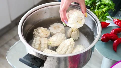 Peruvian corn boiling in a pot, homemade food. Stock Photos