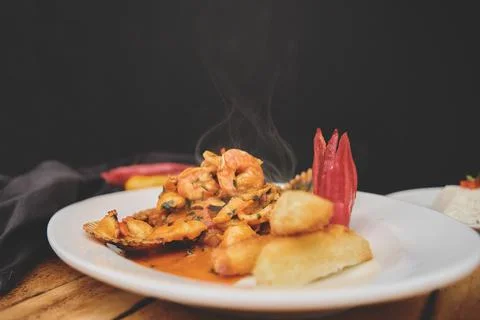 Peruvian culinary fried fish A lo Macho style with seafood sauce Stock-Fotos