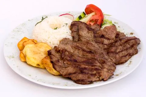 Peruvian Dish: Beef grilled with rice, potatoes and salad.   Foto stock