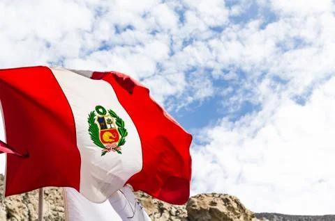 Peruvian flag , blowing in the wind with blue sky Stock Photos