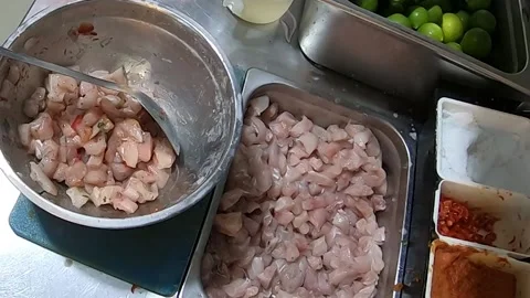 Peruvian food CEVICHE, hands preparing in a saucepan: fish, lemon, onion, salt. Video stock 171408947