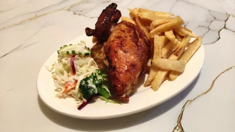 Peruvian fried chicken with fries called "Pollo a la brasa". Food in Peru. Видео 285361645