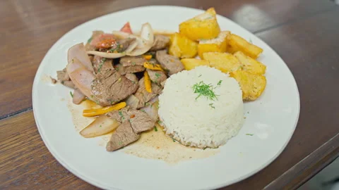 Peruvian Lomo Saltado Dish with Beef Fries and Rice Vídeo Stock 338341710