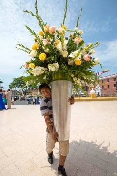 Peruvian man holding a huge vase of flowers, Trujillo Stock Photos