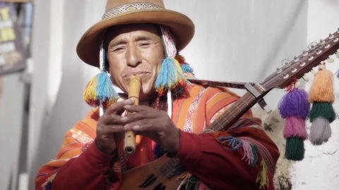 Peruvian man plays flute in the streets of Peru Stock Footage 72663071