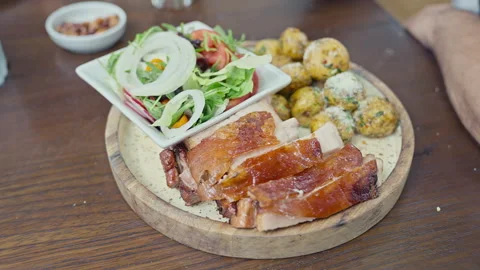 Peruvian roasted pork with crispy skin served with native potatoes Video stock 341440875