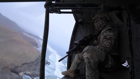 Peruvian Special Forces sniper looking out from Bell 412 helicopter 库存影片 277630821
