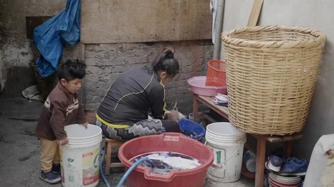 Peruvian Woman doing laundry in Cusco, Peru. Outdoors, dresses. Stock Footage 125288410