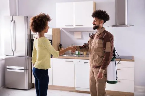 Pest Control Worker Shaking Hands With Woman Stock Photos